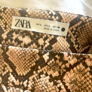 For sale: Croc leather skirt with a front slit, never worn.